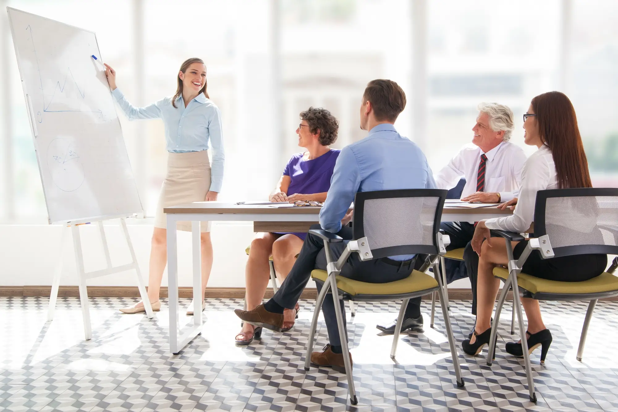 A presenter leading a meeting in a modern office